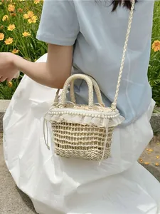 Handcrafted straw woven bucket bag with pearl lace trim and drawstring liner for beach vacations