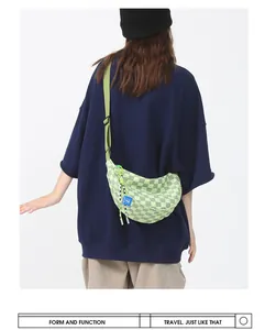 Detail van groen-witte schaakbord crossbodytas met verstelbare nylon schouderband