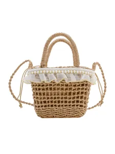 Handwoven straw bucket bag with white lace trim and pearl accents for beach vacations