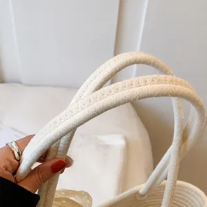Close-up of comfortable woven cotton rope handles on a minimalist beach tote bag