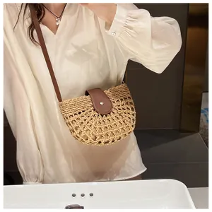 Detail of hollow straw crossbody bag with brown leather flap and magnetic metal snap closure