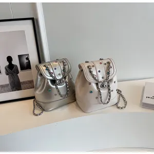 Y2K mini bucket backpacks in silver and beige with colorful rhinestones and chain straps