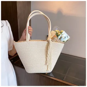 Detail of cream woven cotton rope handbag with lace bow and elegant circular handles