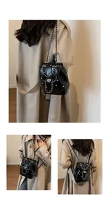 Detail of a mini Y2K black leather backpack featuring colorful rhinestones and silver chains