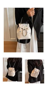 Detail view of Y2K white mini backpack with colorful rhinestones and silver chains