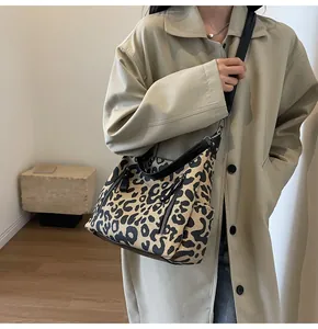 Fashionable leopard print tote bag styled with a khaki trench coat for city commuting