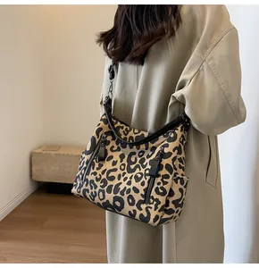 Detail view of stylish leopard print canvas tote bag with adjustable shoulder strap and zippers