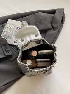 Chic silver Y2K backpack with metallic chain and spacious interior for daily essentials