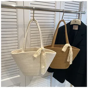 Detail of hand-woven tote bags with lace bow accents for beach vacation style