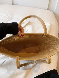 Handcrafted straw woven tote bag with a spacious interior for beach and summer travel