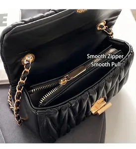Details der schwarzen gesteppten Ledertasche mit goldener Kette und Reißverschluss