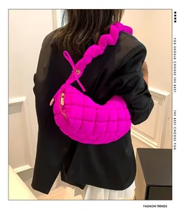 Detailed back view of a bright rose red quilted nylon croissant bag worn by a model