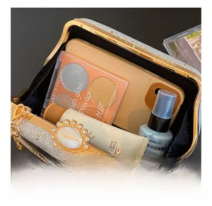 Detail showing internal capacity of the silver sequin evening bag with gold metal frame