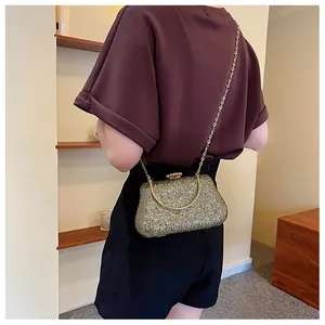 Detailed back view of a sparkling gold glitter evening clutch with chain strap and handle