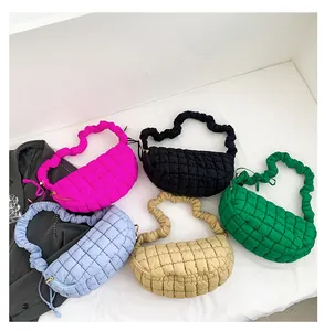 Flat lay of quilted puffer hobo bags in multiple colors with scrunchie strap detail