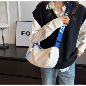 Detail of white nylon crescent bag with blue FASHION letter print wide shoulder strap