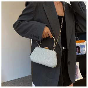 Detailed view of silver sequin evening bag with metallic round handle and chain strap