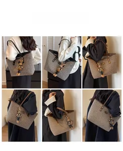 Macro shot of houndstooth tote bag featuring high-quality leather straps and cute rabbit charm