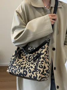 Fashionable leopard print tote bag with black straps and multiple zipper pockets for women