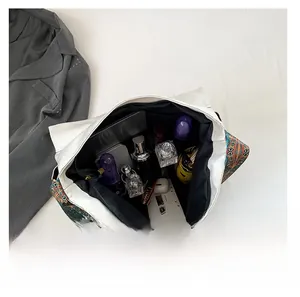 Interior view of white tote bag showing large capacity for essentials with boho strap