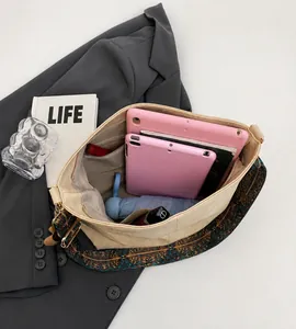 Spacious interior of beige tote bag showing high capacity for tablets and umbrella