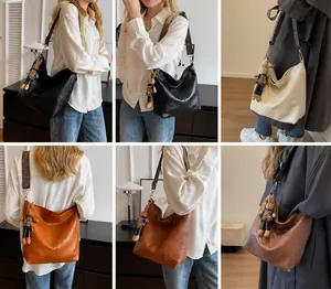 Detail of hobo tote bag featuring a textured finish and geometric ethnic wide strap