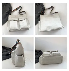 Detail view of large silver grey tote bag with multi-pockets and vintage patterned strap