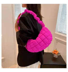Quilted magenta shoulder bag featuring trendy ruched strap and puffy design texture