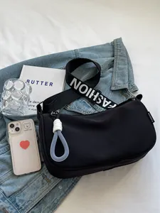 Fashion black crescent dumpling bag with wide shoulder strap and blue charm decor