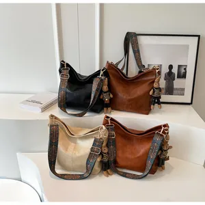 Detailed view of vintage tote bags with ethnic woven straps and cute rabbit pendants