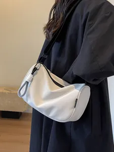 Minimalist white crescent shoulder bag with wide strap and fashion cord detail