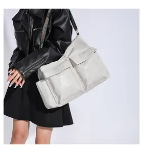 Detail of cream large tote bag with glossy leather and vintage patterned shoulder strap