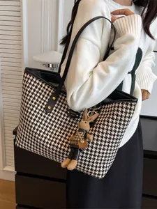 Classic houndstooth tote bag with plush rabbit charm and black leather straps for women