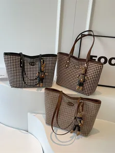 Three large houndstooth tote bags in various colors with cute rabbit doll charms