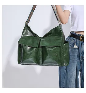 Detail of dark green vintage tote bag with ethnic woven strap and dual front pockets