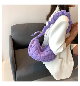 Detail of lavender quilted crescent bag featuring a stylish scrunchie shoulder strap