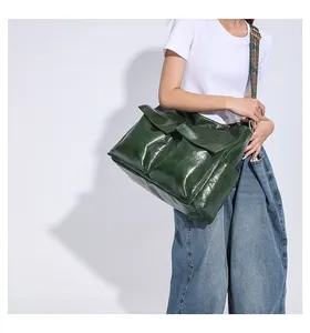 Detail of vintage dark green messenger bag with wide ethnic pattern woven shoulder strap