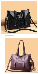 Detail of large tote bag in black and purple lychee leather with metallic accents
