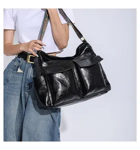 Detail of black PU leather tote bag featuring ethnic style strap and front flap pockets