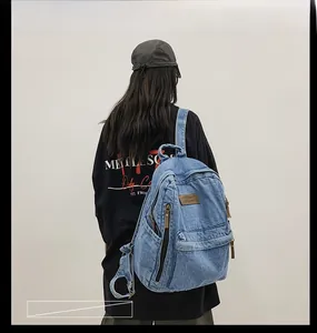 Detail view of large denim backpack with leather patch and durable side pockets
