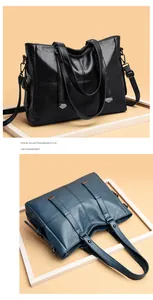 Detail of black and navy blue tote bags with cross stitching and textured synthetic leather