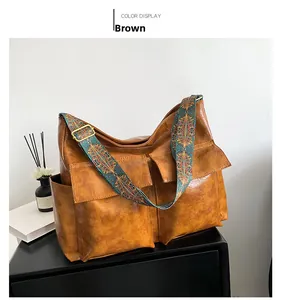 Brown vintage large capacity tote bag with ethnic woven strap detail on cabinet