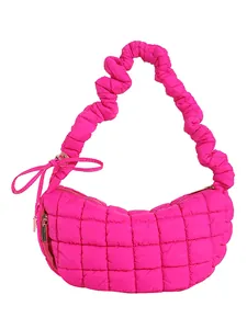 Hot pink quilted crescent shoulder bag with puffy ruffled strap and bow details