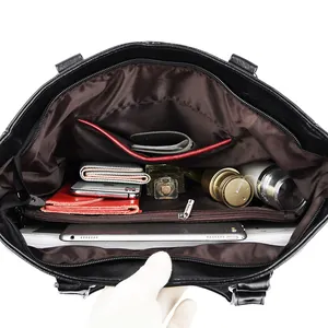 Black large capacity tote bag showing spacious interior with multi-pocket compartments
