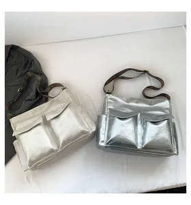 Detail of silver and champagne metallic tote bags with retro patterned shoulder straps