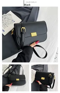 Detail view of black square crossbody bag with adjustable strap and gold metal buckle