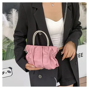 Pink pleated cloud bag with shiny rhinestone circular handles and silver metal chain