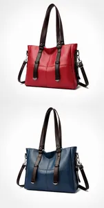 Detail von roten und blauen Leder-Tragetaschen mit Narbenleder und Griffen