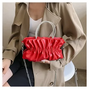 Detailed view of red pleated cloud bag with sparkling rhinestone handles and chain
