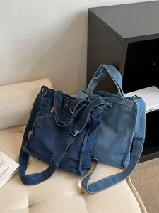 Large denim tote bags in dark and light blue denim with adjustable shoulder straps